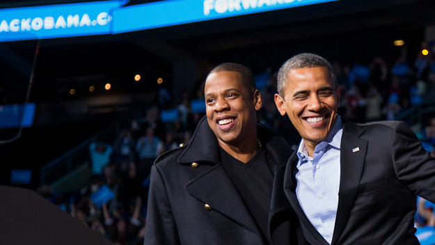 U.S. President Barack Obama stands on stage with rapper Jay Z