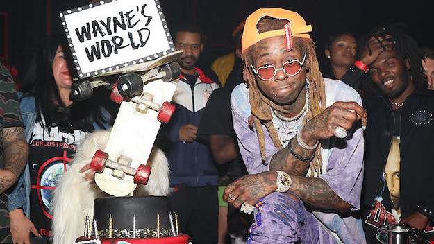 Lil Wayne stands next to his birthday cake.