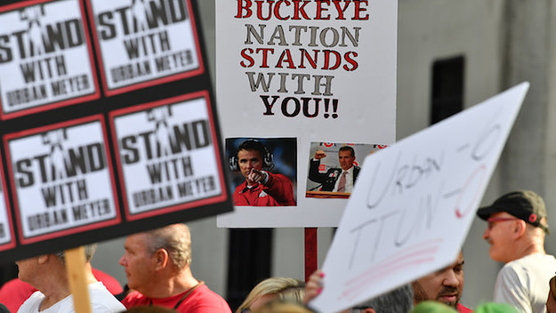 Supporters of Ohio State head football coach Urban Meyer.