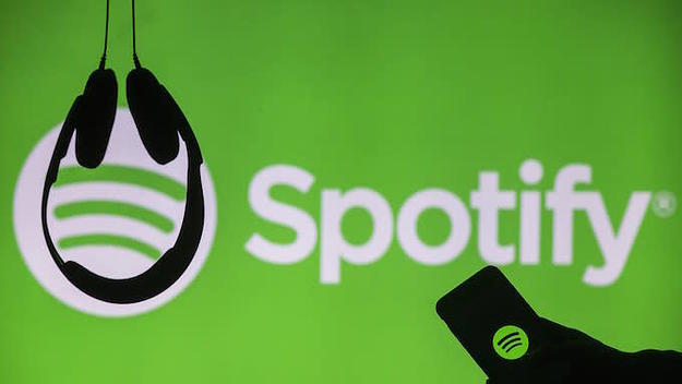 Spotify logo with headphones and cellphone.