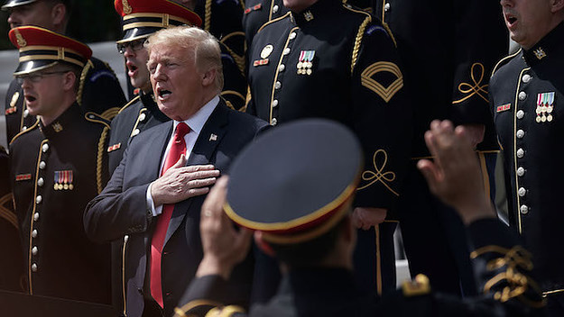 U.S. President Donald Trump fake sings the national anthem.