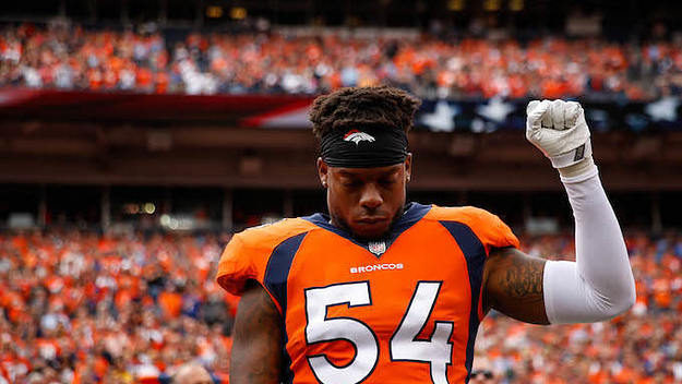 Inside linebacker Brandon Marshall of the Denver Broncos stands and holds a fist in the air.