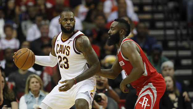 LeBron James #23 of the Cleveland Cavaliers controls the ball against James Harden.