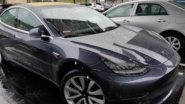 Close up of Tesla Model 3 electric car from Tesla Motors on a rainy day in Dublin, California.