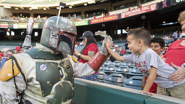 Boba Fett and a young fan high five part of the 'Star Wars Night' promotion.