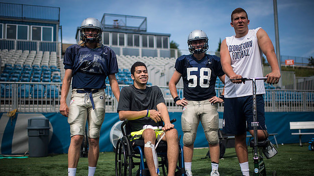 Ty Williams, a linebacker for the Georgetown University Hoyas, talks with other players