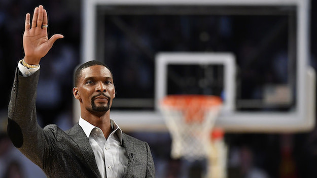 Chris Bosh waves to the crowd during a stoppage in play.