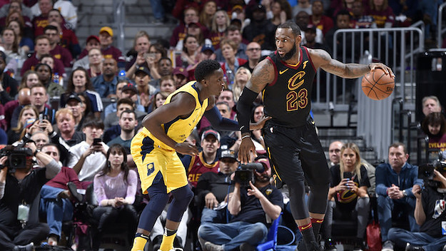 LeBron James #23 of the Cleveland Cavaliers handles the ball against Victor Oladipo.