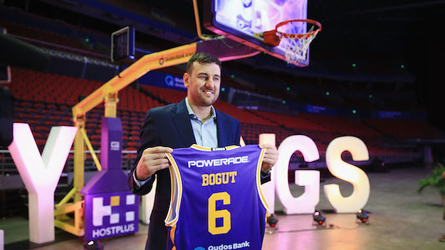 Andrew Bogut holds up a Kings singlet.