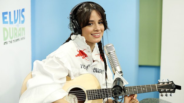 Camila Cabello playing the guitar.