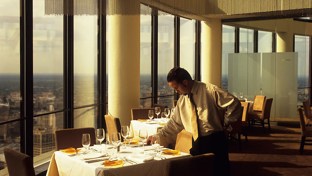A Waiter setting a table.