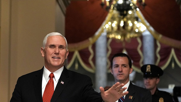 Mike Pence waves as he walks towards the House chamber