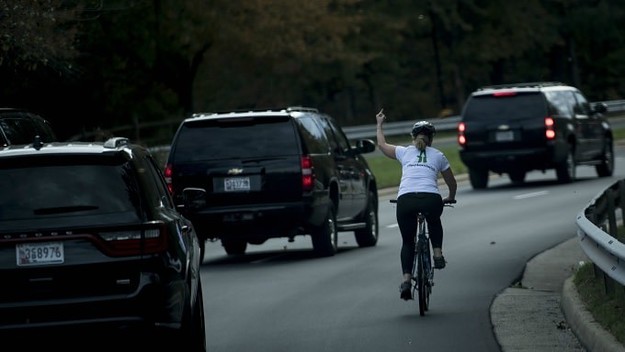 Woman gives Trump the finger.