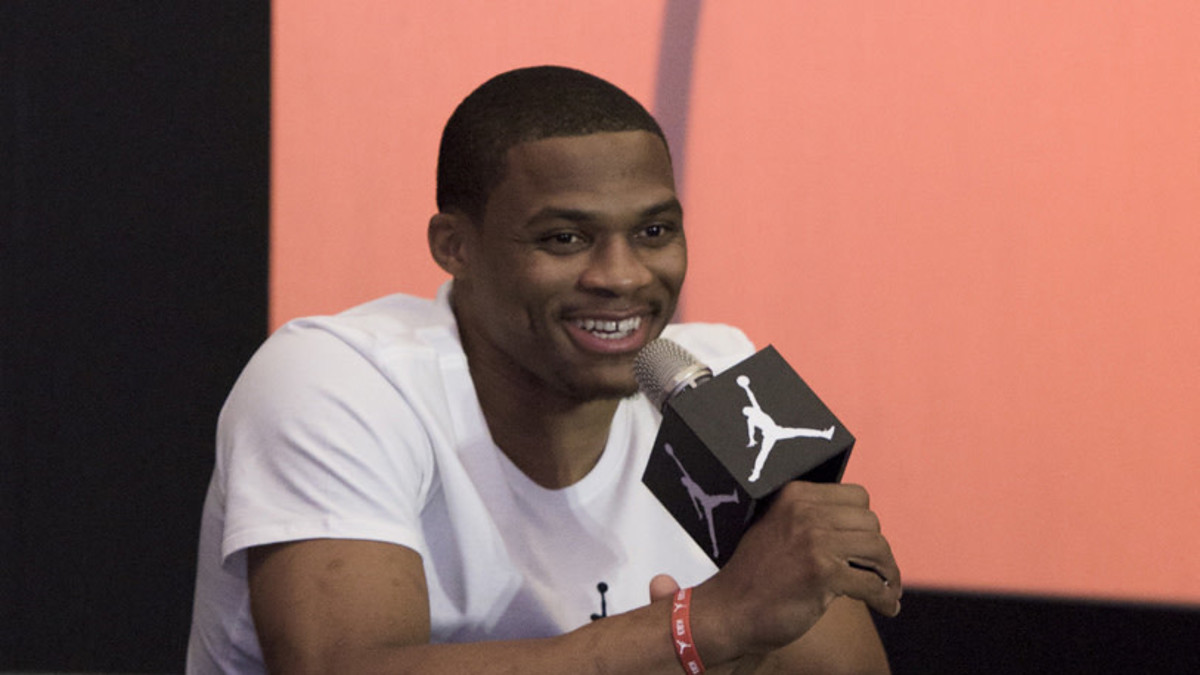 Russell Westbrook holding microphone