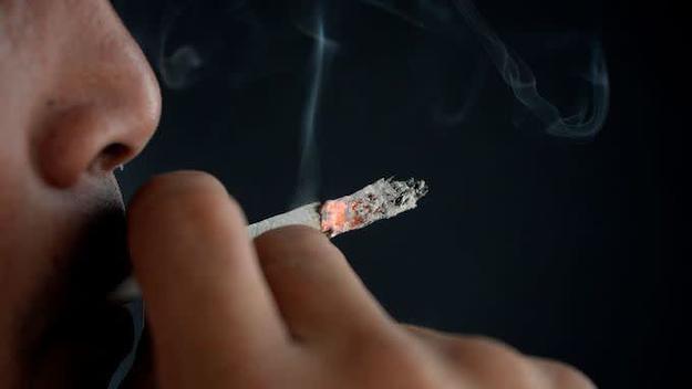 A man smokes a cigarette in Manila on May 19, 2017.