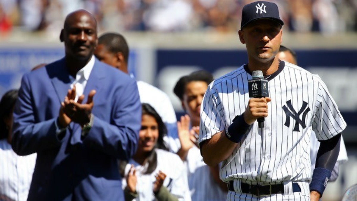 Michael Jordan claps for Derek Jeter.