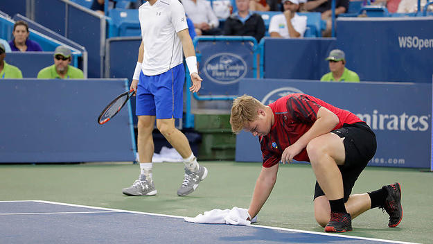 ball boy dries tennis court