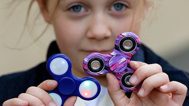 a child shows a 'Hand Spinner' on May 20, 2017 in Paris, France.