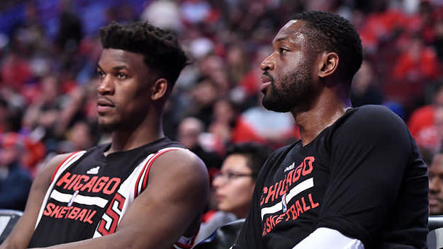 Jimmy Butler and Dwyane Wade sit on the Bulls bench.