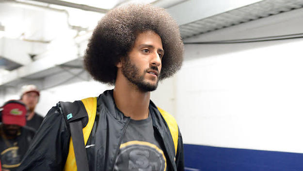 Ex 49ers quarterback Colin Kaepernick arrives with teammates before the game against the Chargers