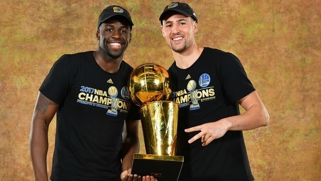 Draymond Green and Klay Thompson celebrate the Warriors' NBA title.