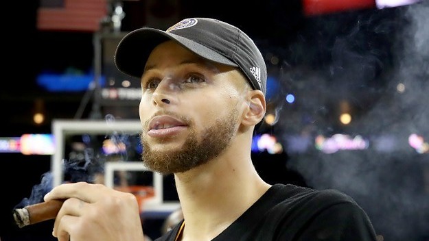 Steph Curry smokes a cigar after winning the 2017 NBA Finals.