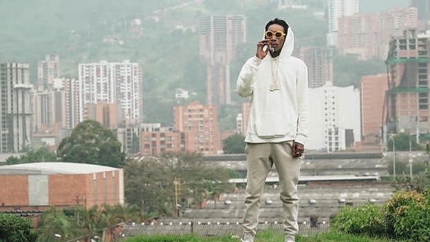 Wiz Khalifa smoking a blunt at Pablo Escobar's grave.