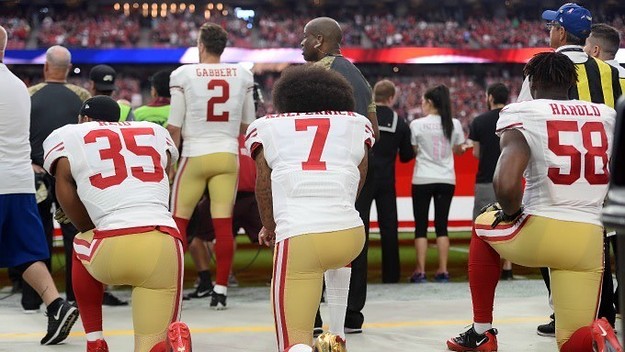 Colin Kaepernick kneels before a 2016 game.
