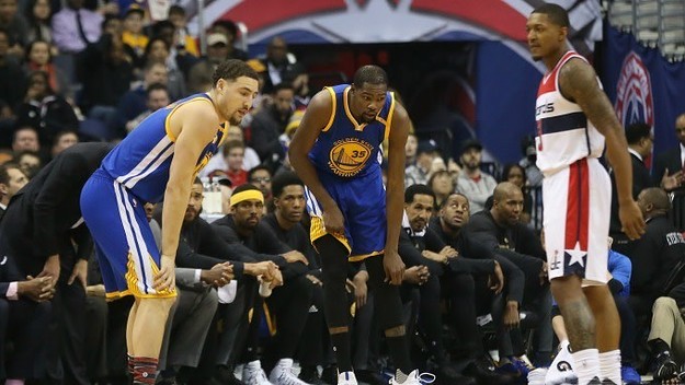 Kevin Durant holds his injured left knee.
