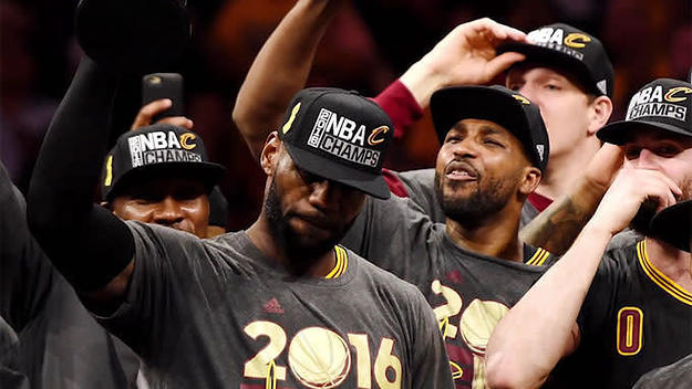LeBron James holds up the trophy after winning the NBA Championship.