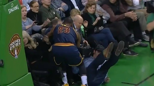 LeBron James nearly collides with Bill Belichick.