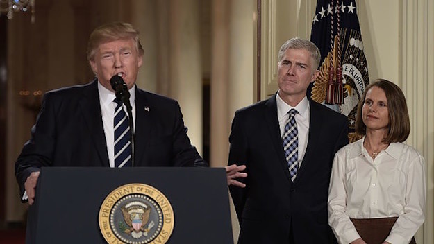 Judge Neil Gorsuch (C) and his wife Marie Louise look on