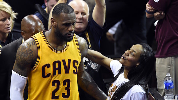 LeBron James passes by his mom Gloria during game.