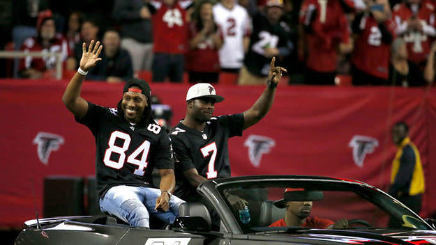Ex Falcons Michael Vick and Roddy White wave to the crowd at the Georgia Dome.