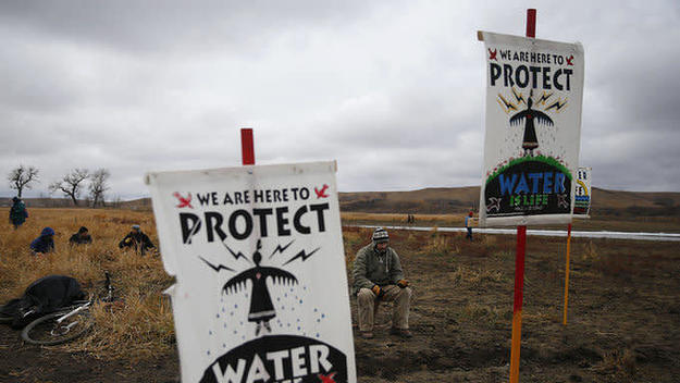 Water protectors protest as police line the hill at Standing Rock on Nov. 24, 2016,