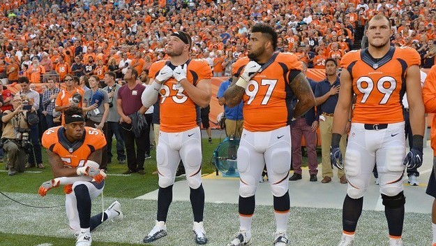 Brandon Marshall kneels during the national anthem.