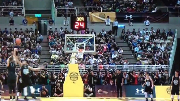 Stephen Curry gets blocked during an exhibition game in China.