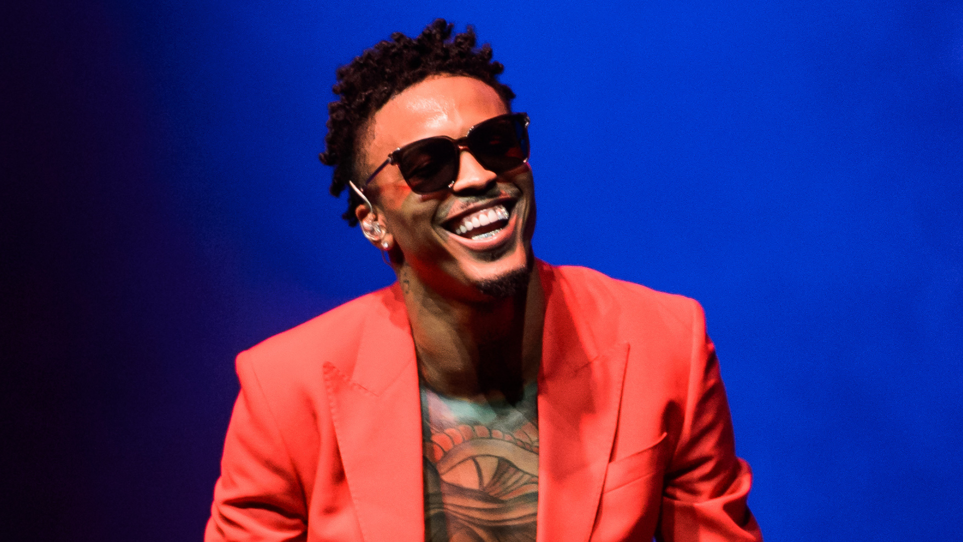 August Alsina performing on stage.