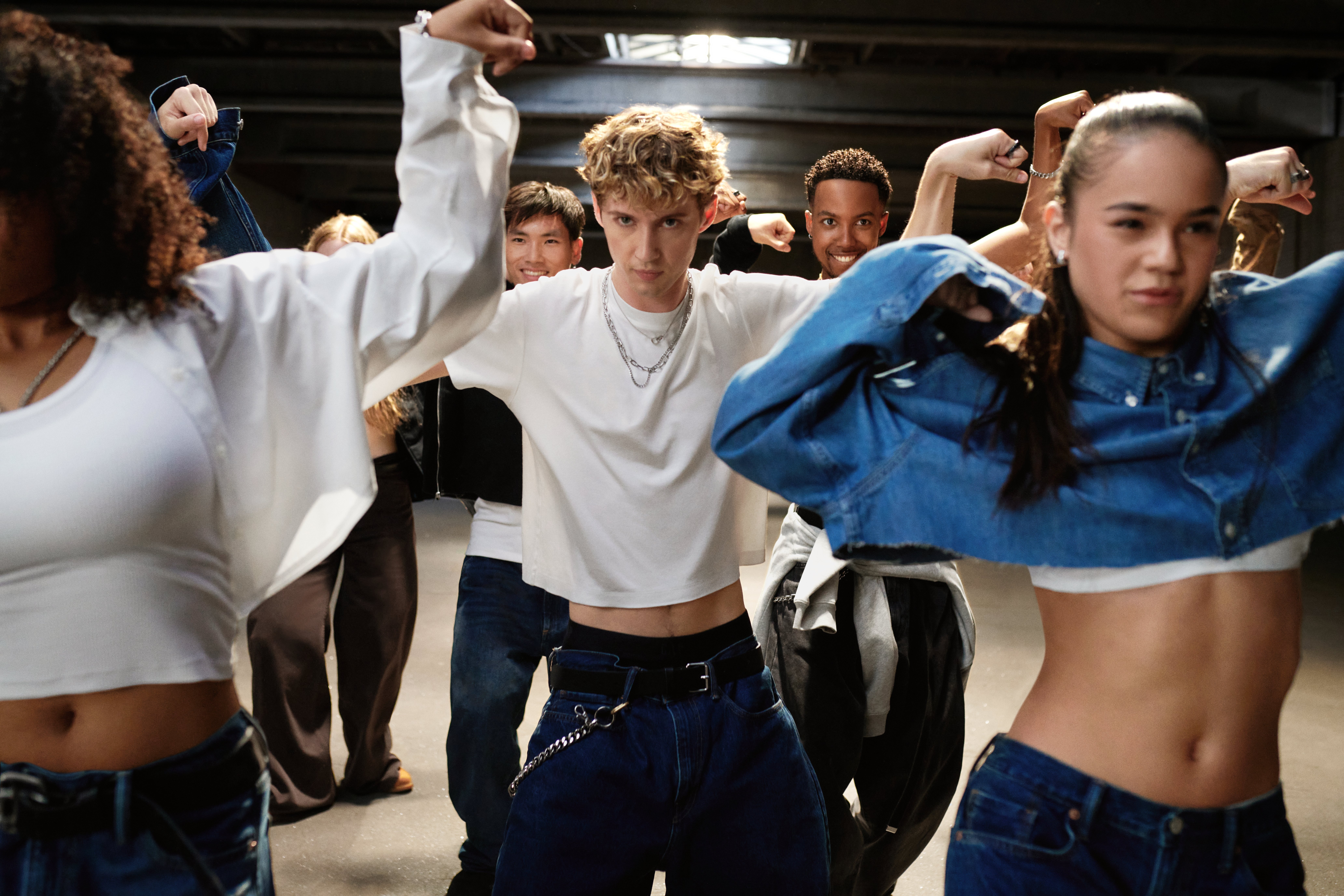 Troye Sivan dancing alongside a group of dancers in the Gap fall campaign 'Get Loose.'