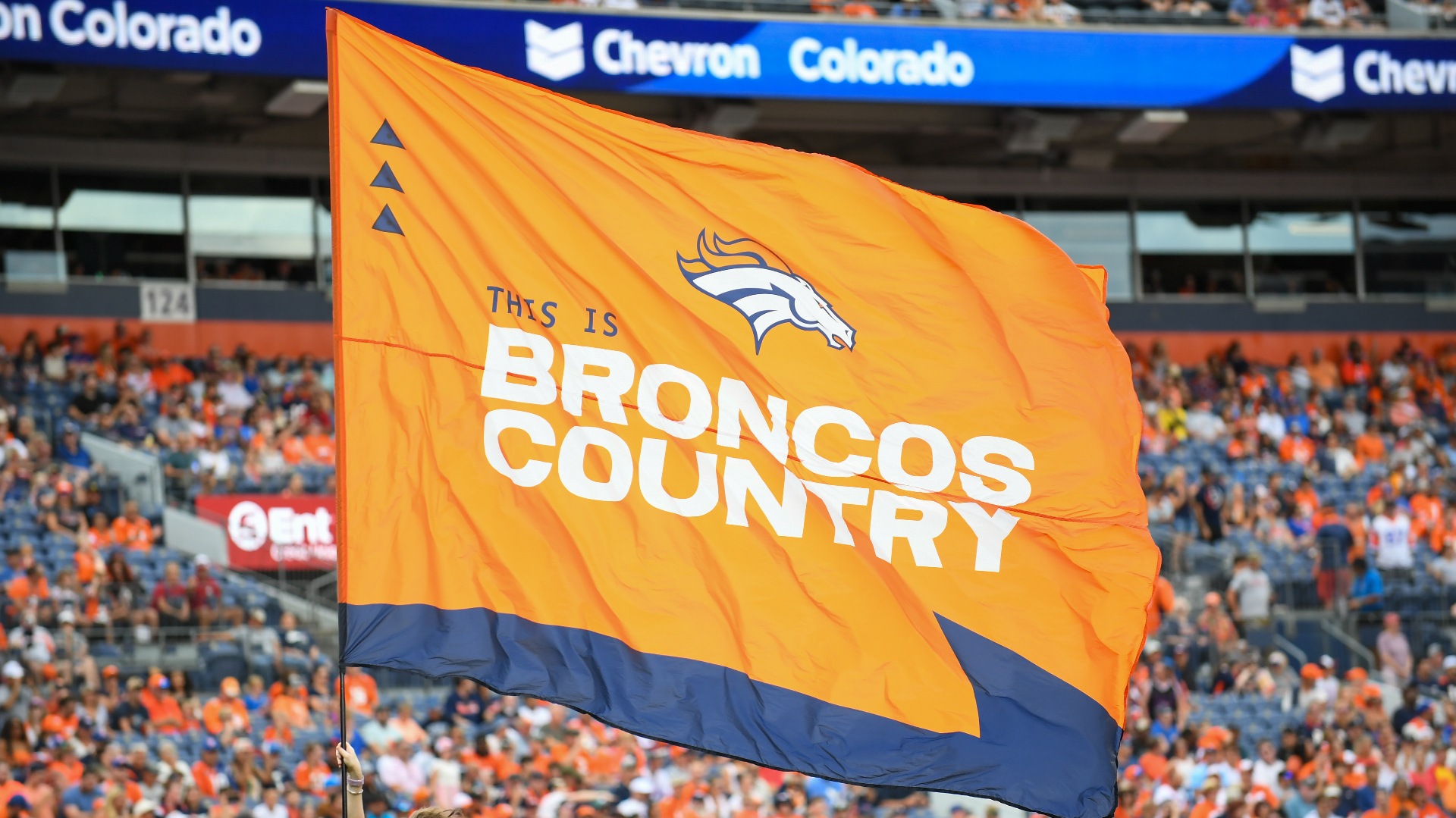 A Denver Broncos flag is flown by a flag attendant during a game between the Denver Broncos and the Arizona Cardinals.