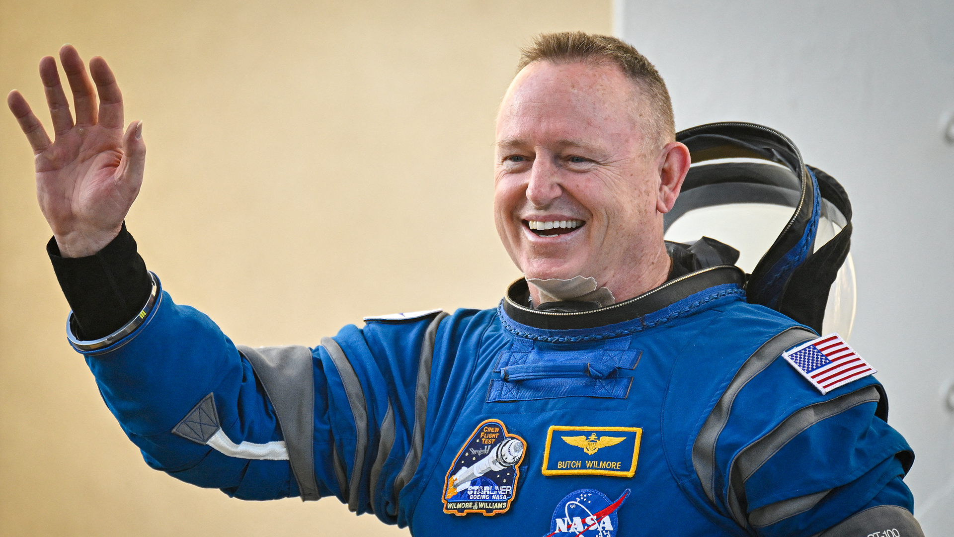 NASA astronaut Butch Wilmore waving before boarding the Boeing Starliner bound for the International Space Station.
