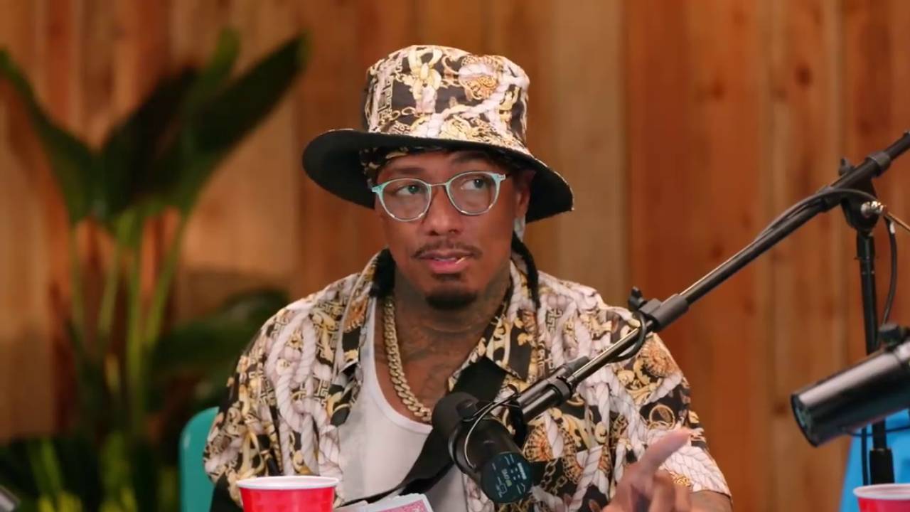 Nick Cannon in front of a podcast microphone