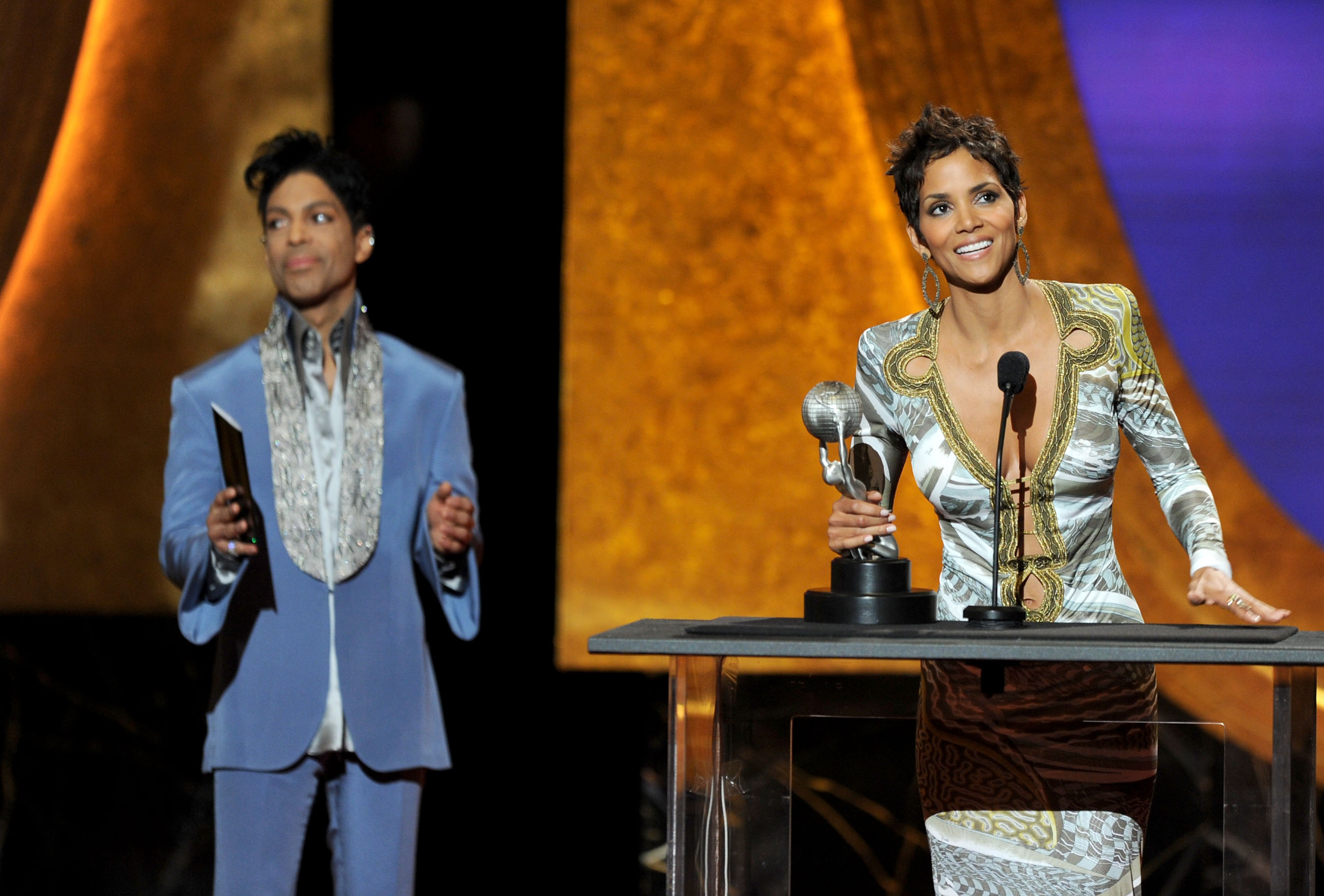 LOS ANGELES, CA - MARCH 04: Actress Halle Berry (R) accepts the award for Outstanding Actress in a Motion Picture for 'Frankie & Alice' from presenter Prince onstage at the 42nd NAACP Image Awards held at The Shrine Auditorium on March 4, 2011 in Los Angeles, California.