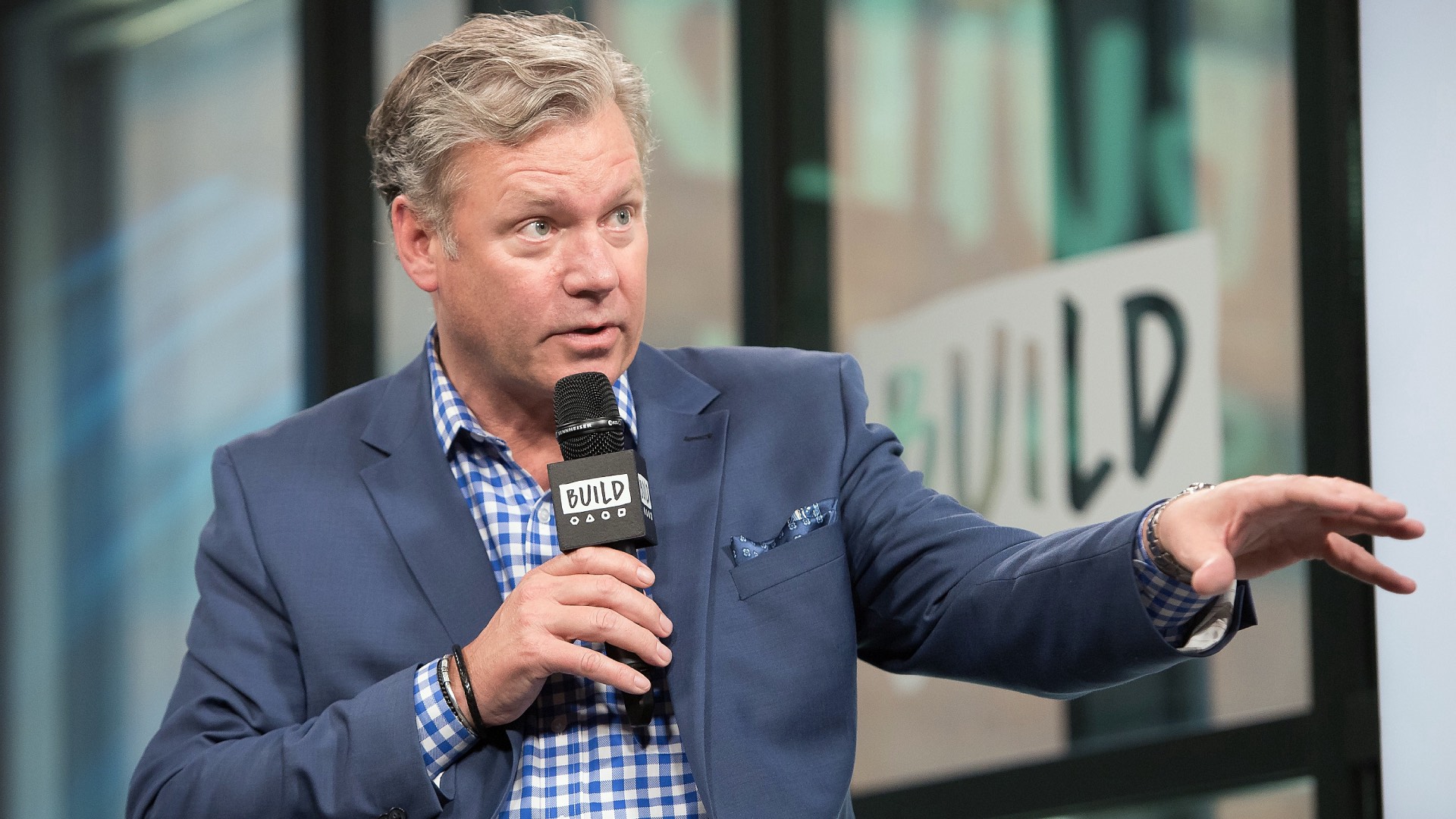 Chris Hansen holds a microphone during a 2017 talk about "Crime Watch Daily" at New York's Build Studio.