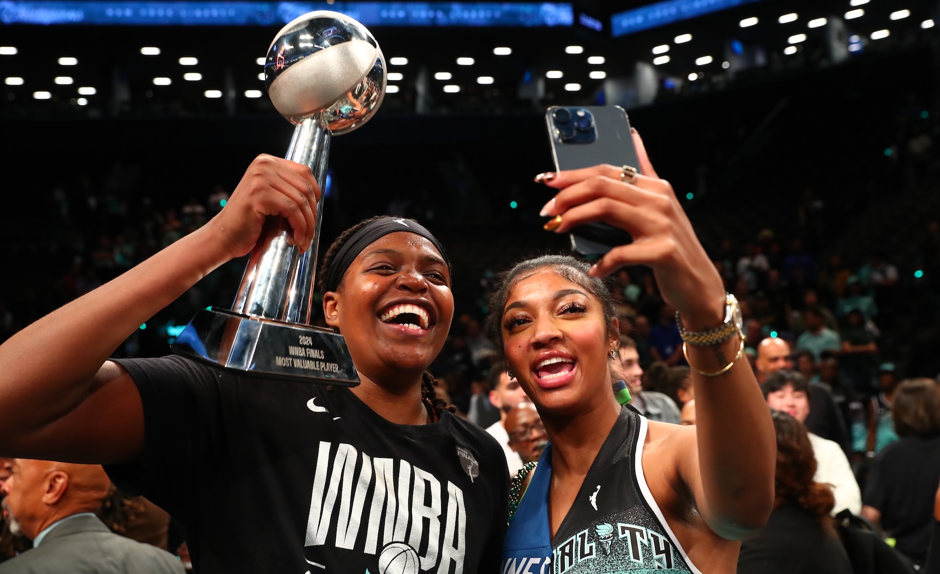 Jonquel Jones #35 of the New York Liberty and Angel Reese celebrate with the 2024 WNBA Finals MVP