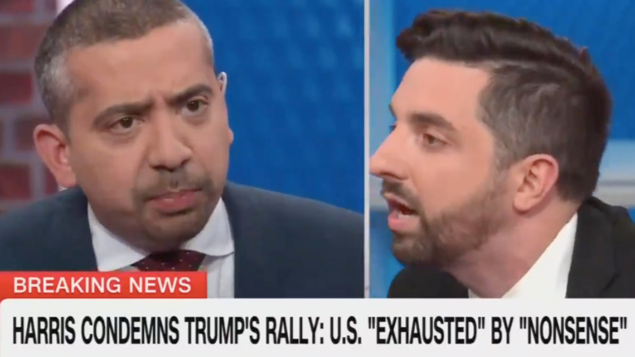 Two men engaged in a heated discussion on CNN, with a "Breaking News" banner about Harris condemning Trump's rally.