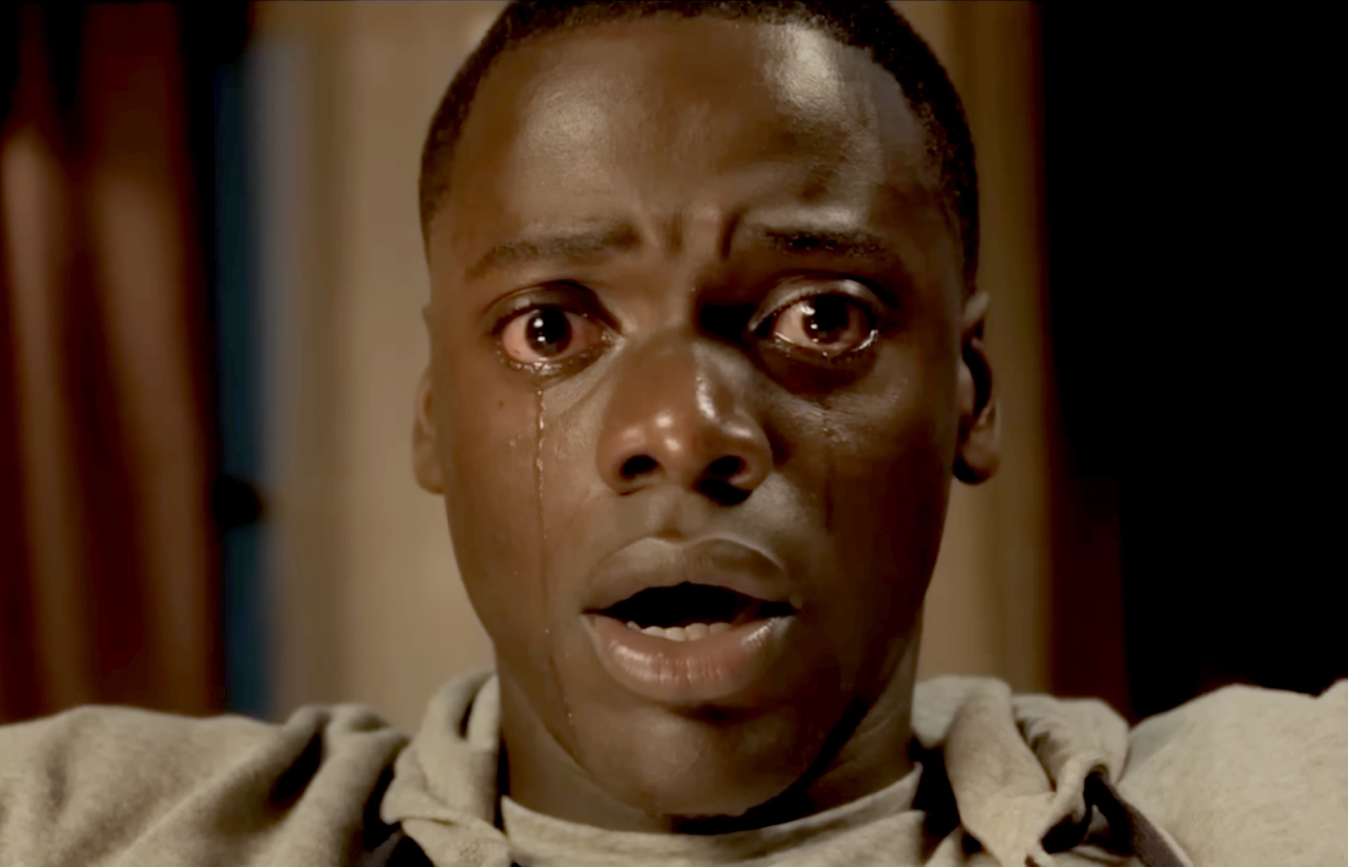 Chris Washington (Daniel Kaluuya) stares into the camera as tears stream down his face.