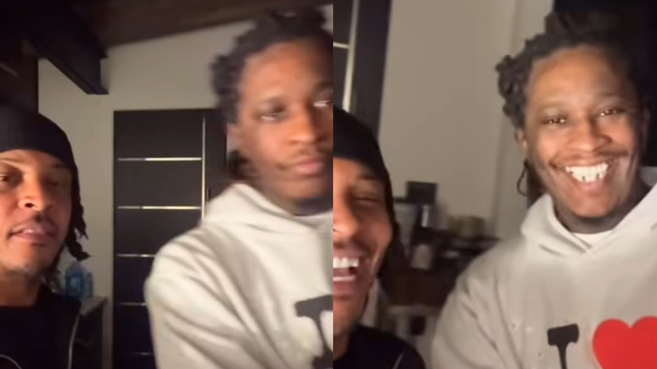 Two men are smiling in a room. One wears a black headscarf, the other a white hoodie with a red heart.