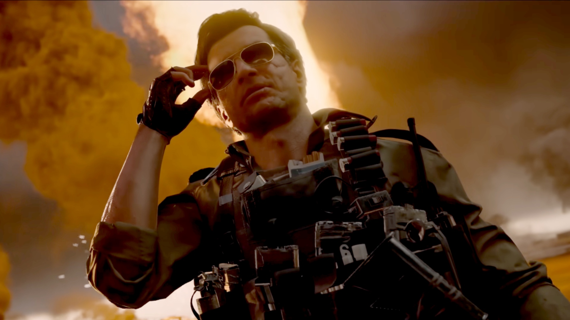 A rugged soldier in military gear and sunglasses stands against a dramatic, fiery background.