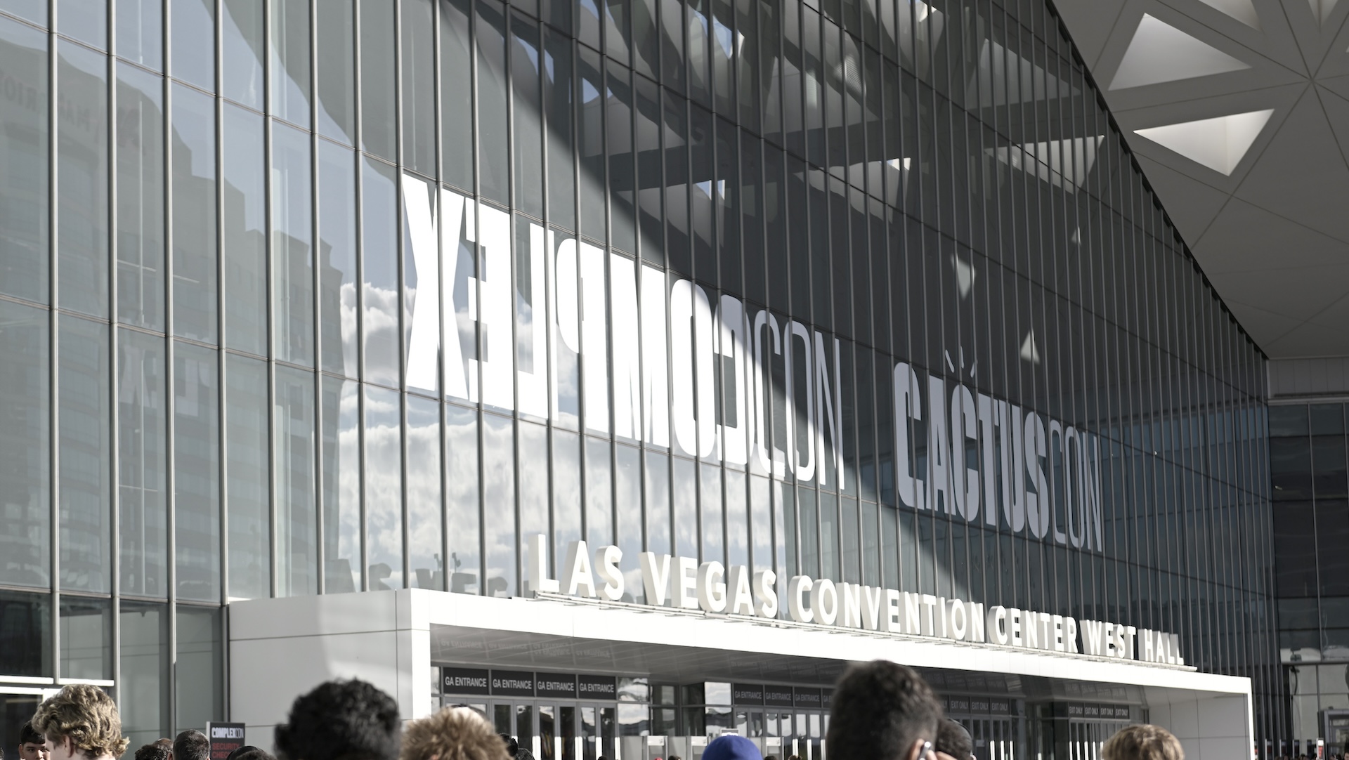 People gathered outside the Las Vegas Convention Center West Hall, with large reflective windows and signage visible for ComplexCon 2024.